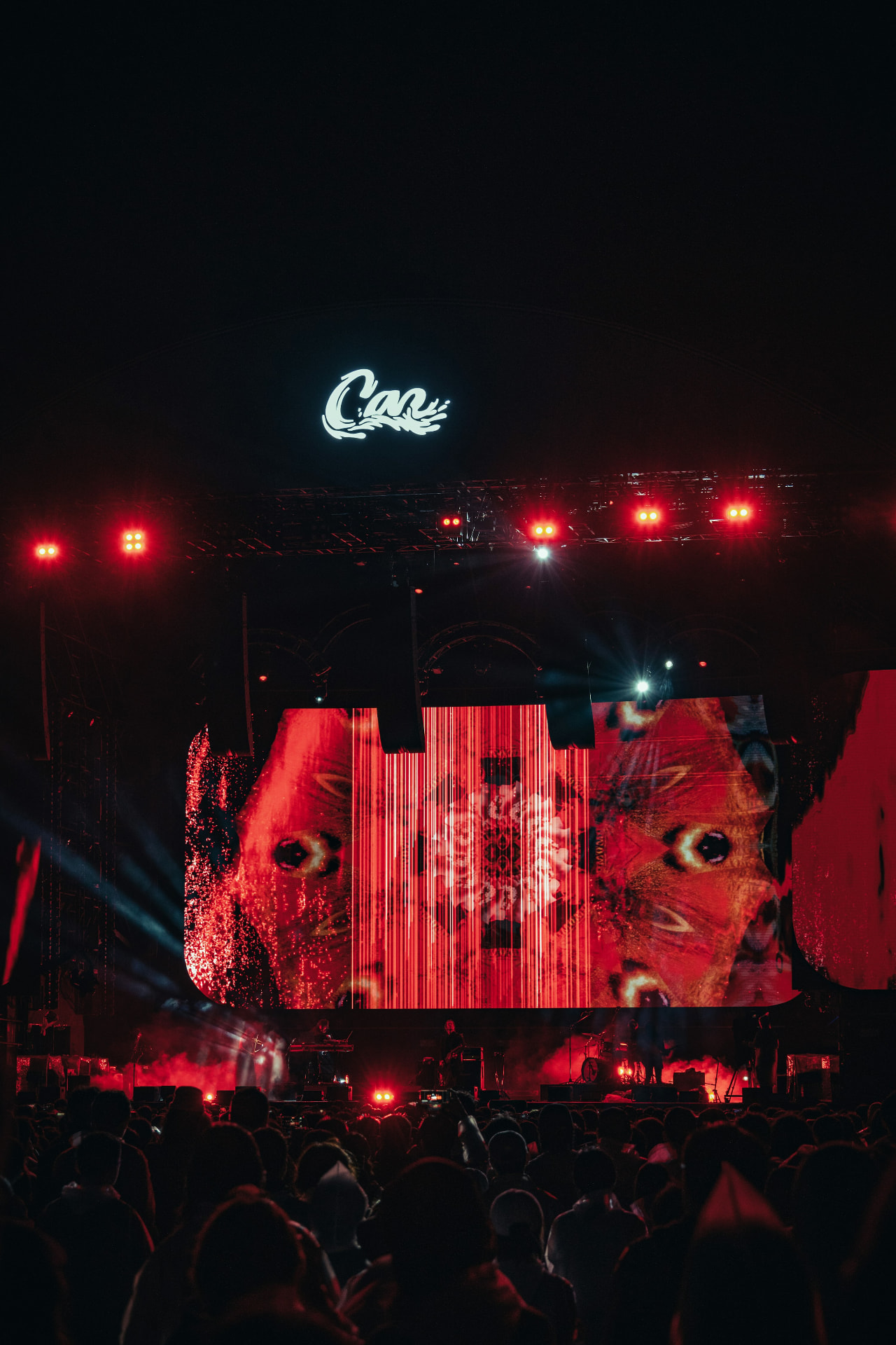 Concert crowd under red stage lights where custom Original Air Drums turn fans into participants